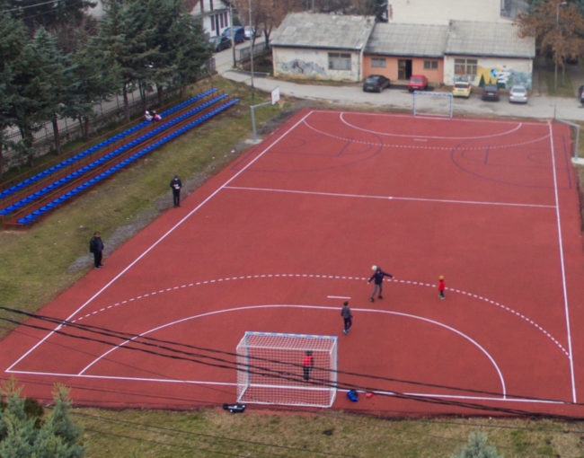 Реконструкција на спортско игралиште во СОУ Гимназија Гоце Делчев со комплет голови, кошеви, трибина и поставување на мека спортска тартан подлога